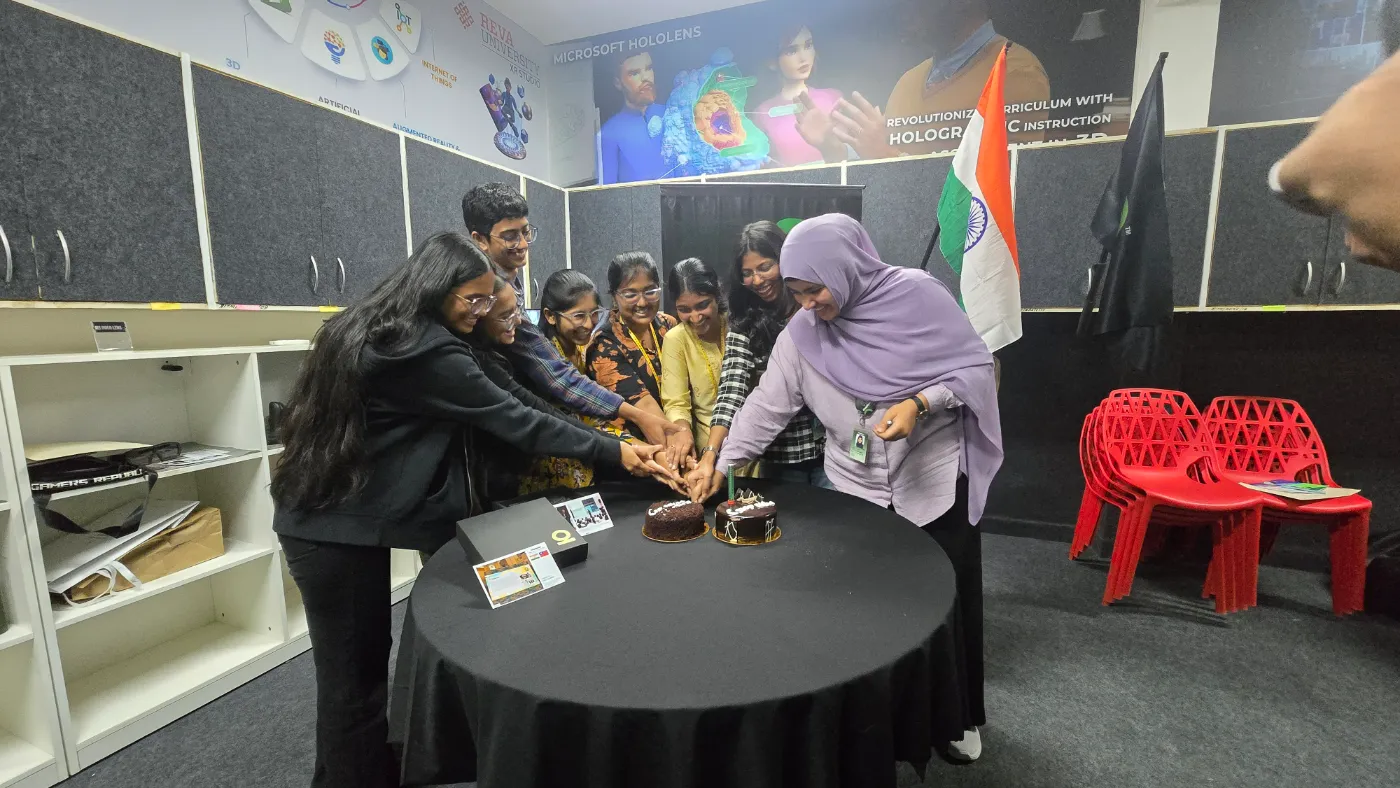 The team celebrating together beside the Indian flag
