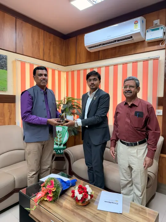 Mohammed Kabeer receiving a gift from an official, with another official beside them
