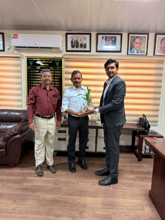 Mohammed Kabeer with two officials in an office
