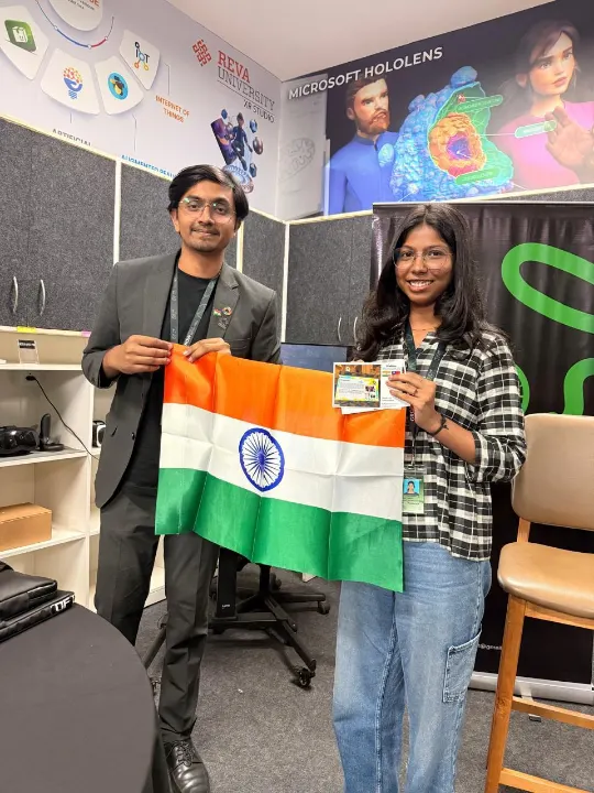 Two team members holding the Indian flag