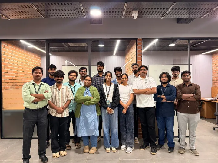 The team standing together in an office