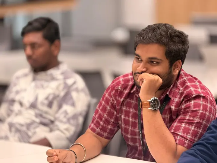 Two team members listening at a table