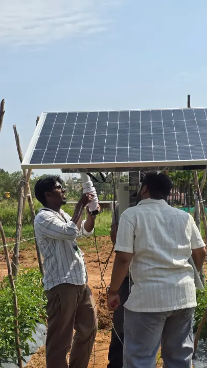 Two people installing a solar-powered field station