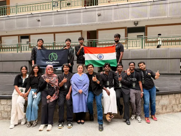 The CropNow team with the Indian flag and a CropNow banner