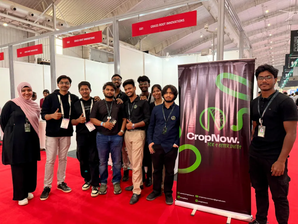 The team at an exhibition stall beside a CropNow banner
